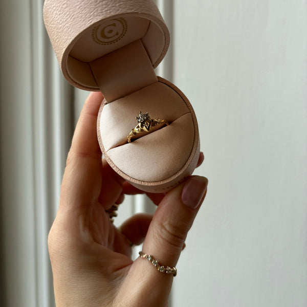 Alternative view of Close-up of a hand wearing the Diamond Crown Claddagh North Star Gold Ring in 14k solid gold, showing the diamond crown.