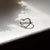 Side profile of the Love Heart Ring in sterling silver, showcasing the polished band and heart-shaped detail.