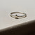 Side profile of the Sterling Silver Star Ring, showing the polished band and subtle star detail.