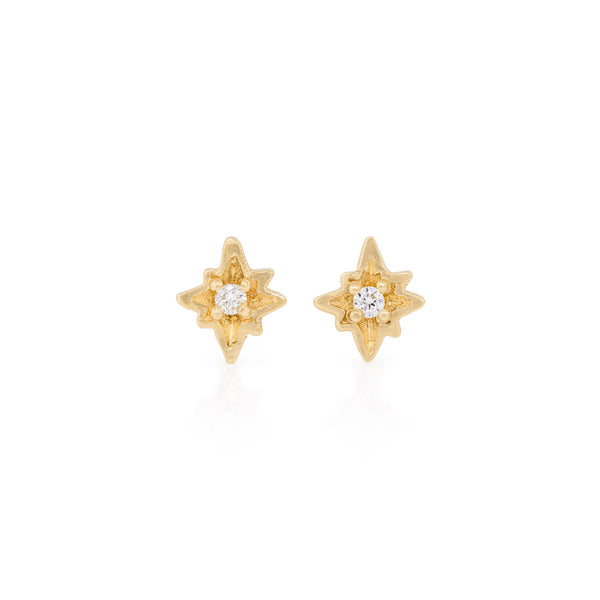 Front view of the North Star Diamond Stud Earrings in 14k gold, featuring a bezel-set diamond in a starburst setting.