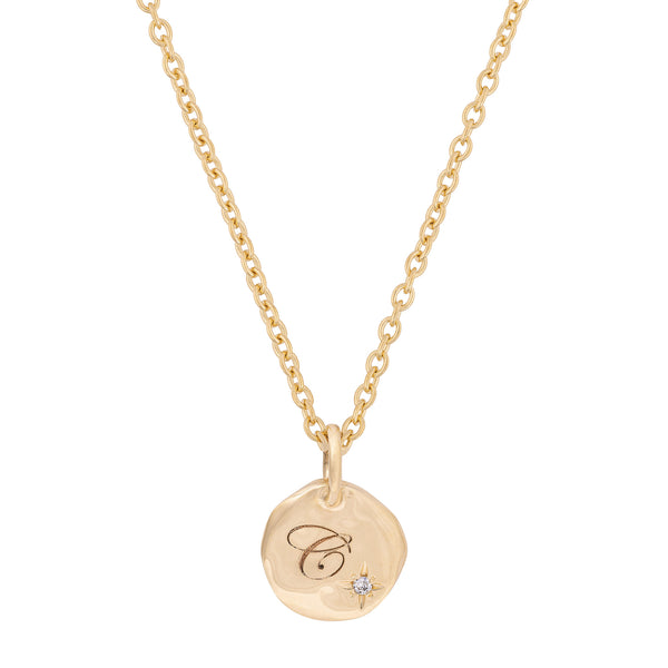 Front view of the North Star Diamond Engraved Initial Necklace in 14k gold, featuring an engraved disc pendant with a small diamond.