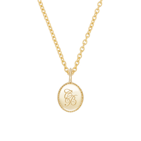 Alternative view of Close-up of the Always Remember Engraved Necklace in 14k solid gold, showing the subtle hand-engraved detail on the circular pendant.