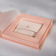 Open blush pink Chupi luxury packaging sleeve, revealing a necklace box inside.