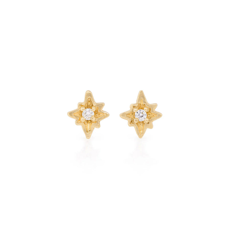 Front view of the North Star Diamond Stud Earrings in 14k gold, featuring a bezel-set diamond in a starburst setting.