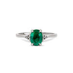 Front view of the Dewlight Emerald Engagement Ring in 14k white gold, featuring a large oval stone on a polished band.