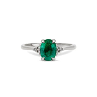Front view of the Dewlight Emerald Engagement Ring in 14k white gold, featuring a large oval stone on a polished band.