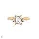 Front view of the Hero Emerald Cut Three Stone Diamond Engagement Ring in 14k solid gold, featuring a central 1.5ct emerald-cut diamond flanked by two smaller diamonds on a polished band.