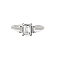 Front view of the Hero Emerald Cut Three Stone Diamond Engagement Ring in 14k solid white gold, featuring a central 1ct emerald-cut diamond flanked by two smaller diamonds on a polished band.