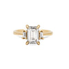 Thumbnail of Front view of the Hero Emerald Cut Three Stone Diamond Engagement Ring in 14k solid gold, featuring a central 2ct emerald-cut diamond flanked by two smaller diamonds on a polished band.