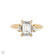 Front view of the Hero Emerald Cut Three Stone Diamond Engagement Ring in 14k solid gold, featuring a central 2ct emerald-cut diamond flanked by two smaller diamonds on a polished band.