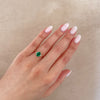 Thumbnail of Close-up of a hand wearing the Dewlight Emerald Engagement Ring in 14k white gold, on a polished band.