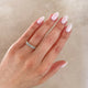 Close-up of a hand wearing the Everlasting Oval Eternity Ring in 14k white gold.