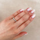 Close-up of a hand wearing the Forever Diamond Eternity Ring in 14k solid gold.