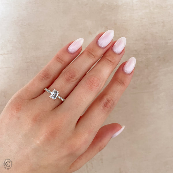 Alternative view of Close-up of a hand wearing the Heritage Eternity Emerald Cut Diamond Engagement Ring in 14k white gold.