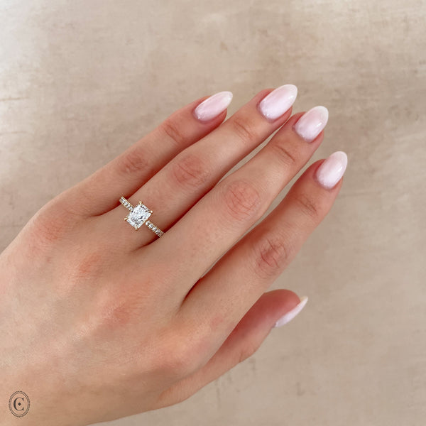 Alternative view of Close-up of a hand wearing the Heritage Eternity Radiant Cut Diamond Engagement Ring in 14k white gold.