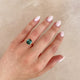 Close-up of a hand wearing the Hero 1.8ct Green Tourmaline & Diamond Ring in 14k polished white gold.