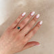 Close-up of a hand wearing the Hero 1ct Green Tourmaline Ring in 14k white gold.