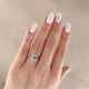 Close-up of a hand wearing the Hero Emerald Cut Three Stone Diamond Engagement Ring in 14k solid gold.