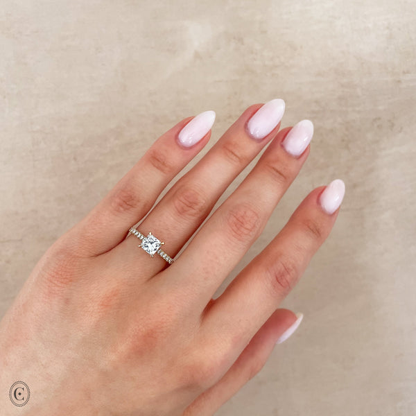 Alternative view of Close-up of a hand wearing the Love’s Life Eternity Princess Cut Diamond Engagement Ring in 14k white gold.