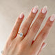 Close-up of a hand wearing the Moonlight Oval Diamond Engagement Ring in 14k white gold, on a polished band.