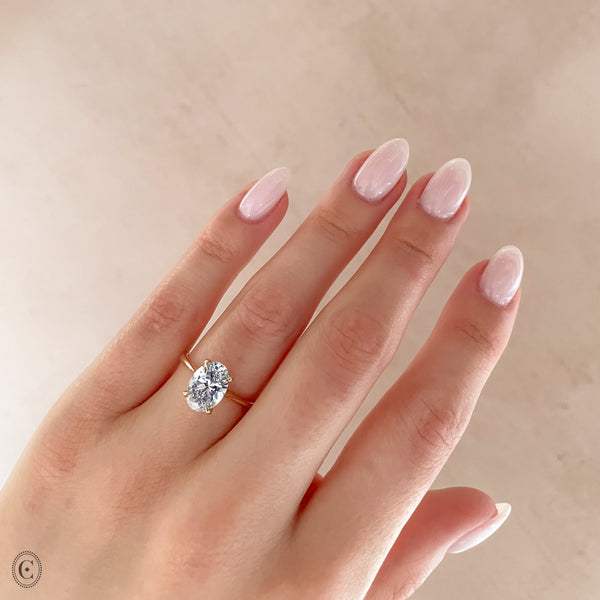 Alternative view of Close-up of a hand wearing the Moonlight Oval Diamond Engagement Ring in 14k white gold, on a twig band.