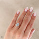 Close-up of a hand wearing the Moonlight Oval Diamond Engagement Ring in 14k white gold, on a twig band.