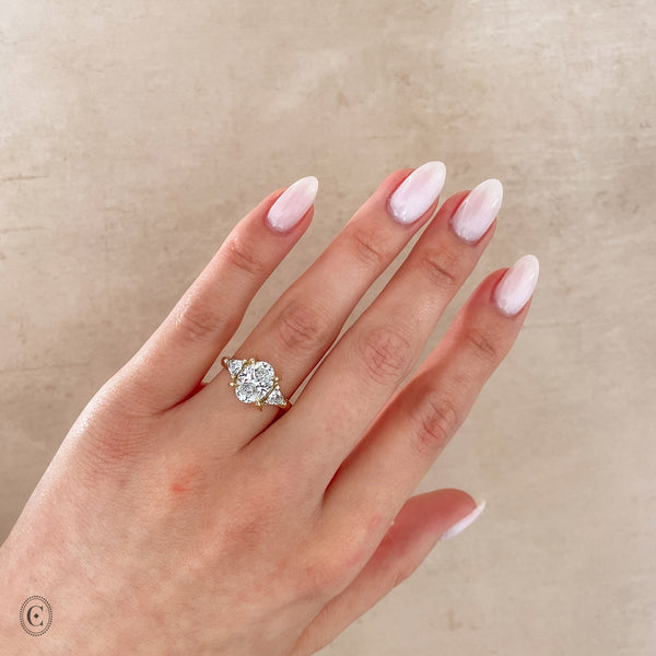 Alternative view of Close-up of a hand wearing the One in a Trillion 2.4ct Lab-Grown Oval Diamond Engagement Ring in 14k white gold with a twig band.