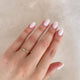 Close-up of a hand wearing the Promise Me Diamond Ring in 14k gold.