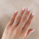Close-up of a hand wearing the Starlight Oval Diamond Engagement Ring in 14k white gold.