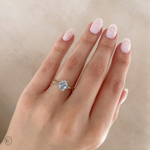 Alternative view of Close-up of a hand wearing the Starlight Oval Diamond Engagement Ring in 14k white gold.