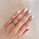 Close-up of a hand wearing the Whispered Dreams Diamond Double Cluster Ring in 14k white gold.