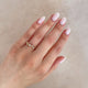Close-up of a hand wearing the Whispered Dreams Lab-Grown Diamond Cluster Ring in 14k solid gold.