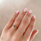 Close-up of a hand wearing the You, Me & Magic Grey Diamond Engagement Ring in 14k solid gold, on a polished band.