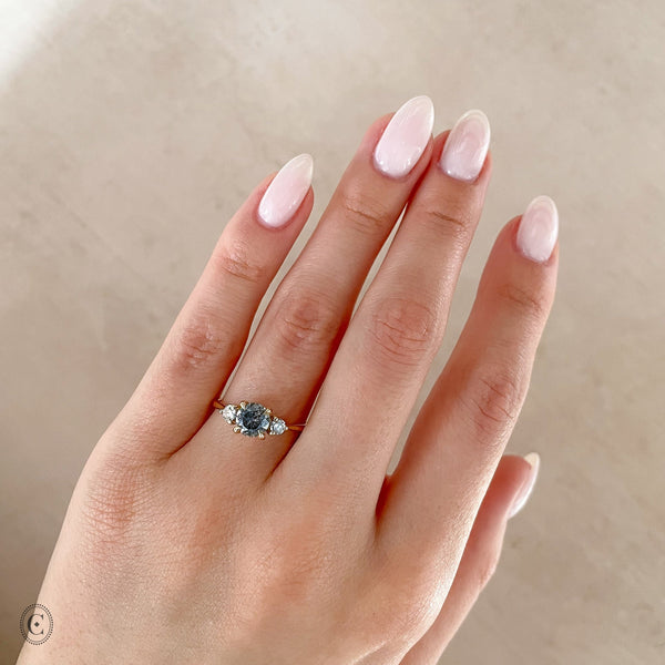 Alternative view of Close-up of a hand wearing the You, Me & Magic Grey Diamond Engagement Ring in 14k white gold, on a twig band.