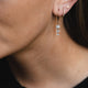 Raindrop Diamond Earrings in 14k gold on a model's ear, highlighting the clustered diamond arrangement.