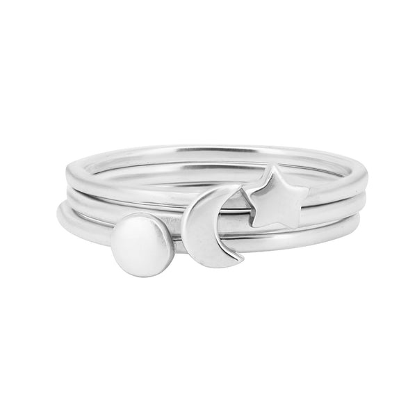 Front view of the Sterling Silver Sun, Moon & Star Ring Stack, showcasing three delicate, polished sterling silver rings with a sum, moon and star.