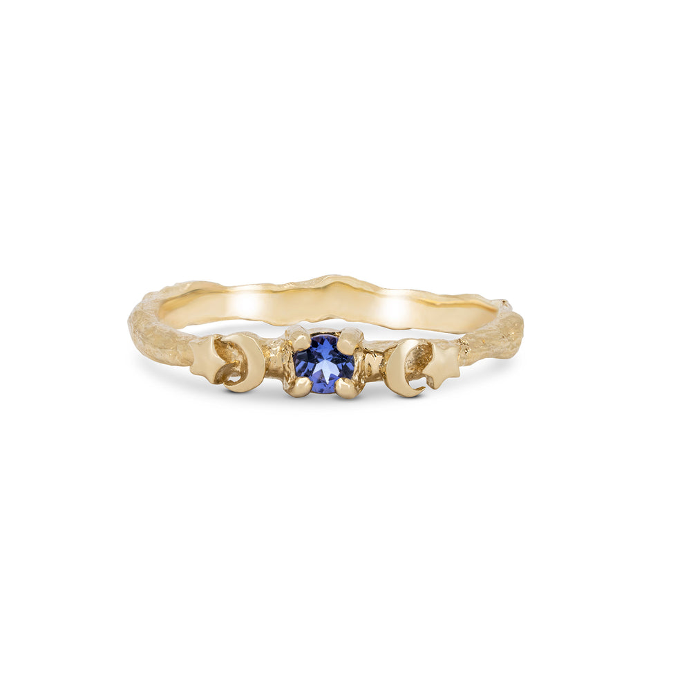 Front view of the Sun, Moon & Stars Tanzanite Ring in 14k solid gold, featuring a round tanzanite stone flanked by sun, moon, and star motifs on a twig band.