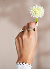 Hand with Chupi rings holding a flower