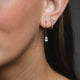 Teardrop Diamond Earrings in 14k white gold on a model's ear, highlighting the clustered diamond arrangement.