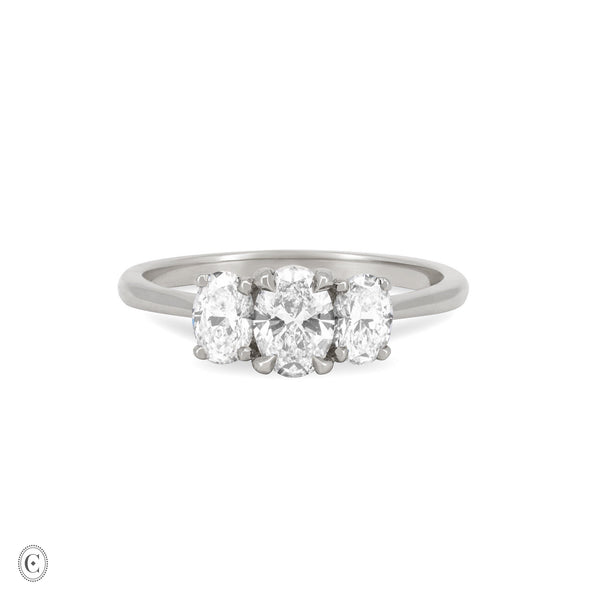 Front view of the Guiding Light Trilogy Oval Diamond Engagement Ring in 14k white gold, featuring a central oval diamond flanked by two smaller diamonds on a polished band.