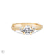Front view of the You, Me & Magic Round Cut Three Stone Engagement Ring in 14k solid gold, featuring a 0.5ct central round cut diamond flanked by two smaller stones on a twig band.