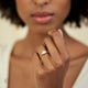 Close-up of a hand wearing the Heart's Light Three Stone Diamond Engagement Ring in 14k white gold.