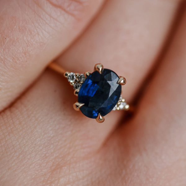 On-body shot of Dewlight 1ct Blue Sapphire Oval Engagement Ring - 14k White Gold Polished Band