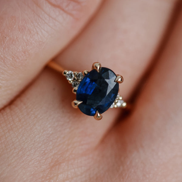 On-body shot of Dewlight 1ct Blue Sapphire Oval Engagement Ring - 14k Gold Polished Band